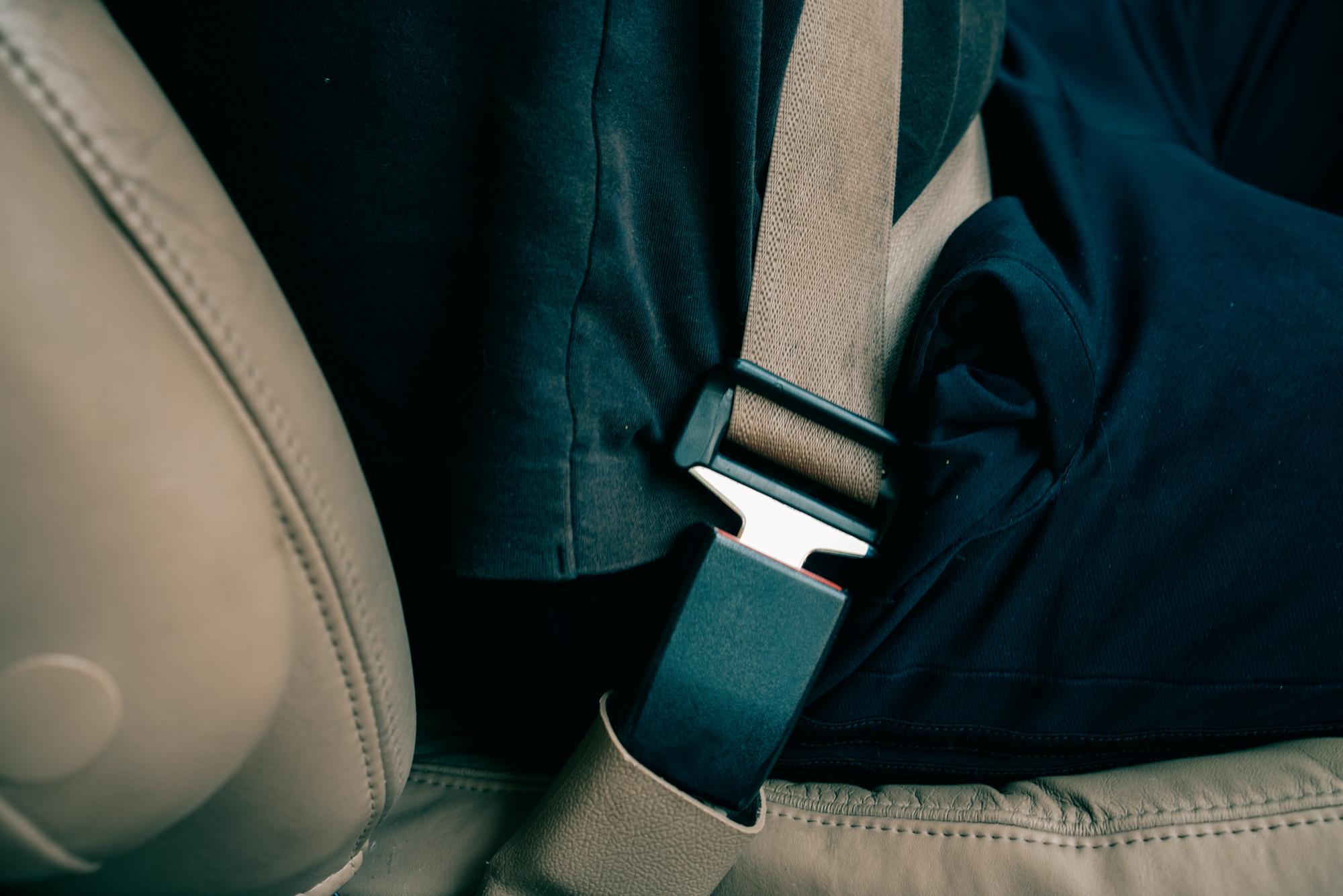 Vehicle seatbelt fastened across a passenger's shoulder in Sacramento, California