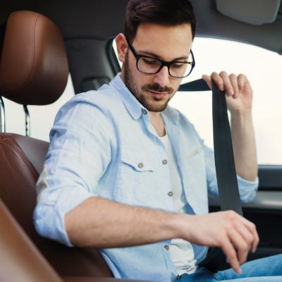 Roseville defective seatbelt attorney inspecting a seatbelt latch